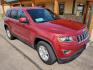 2015 Red /Black Jeep Grand Cherokee Laredo (1C4RJFAG7FC) with an 3.6L V6 24Valve Variable Valve Timing engine, 8_Speed Automatic transmission, located at 1600 E Hwy 44, Rapid City, SD, 57703, (605) 716-7878, 44.070232, -103.171410 - Photo #0