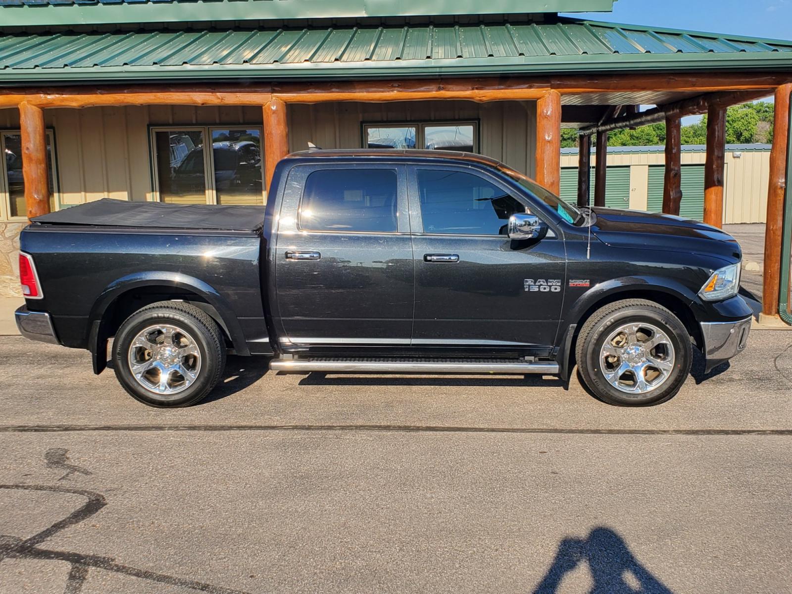 2016 Black /Black Ram 1500 Laramie (1C6RR7NT3GS) with an 5.7L V-8 Hemi engine, 8-Speed Automatic transmission, located at 1600 E Hwy 44, Rapid City, SD, 57703, (605) 716-7878, 44.070232, -103.171410 - Photo #4