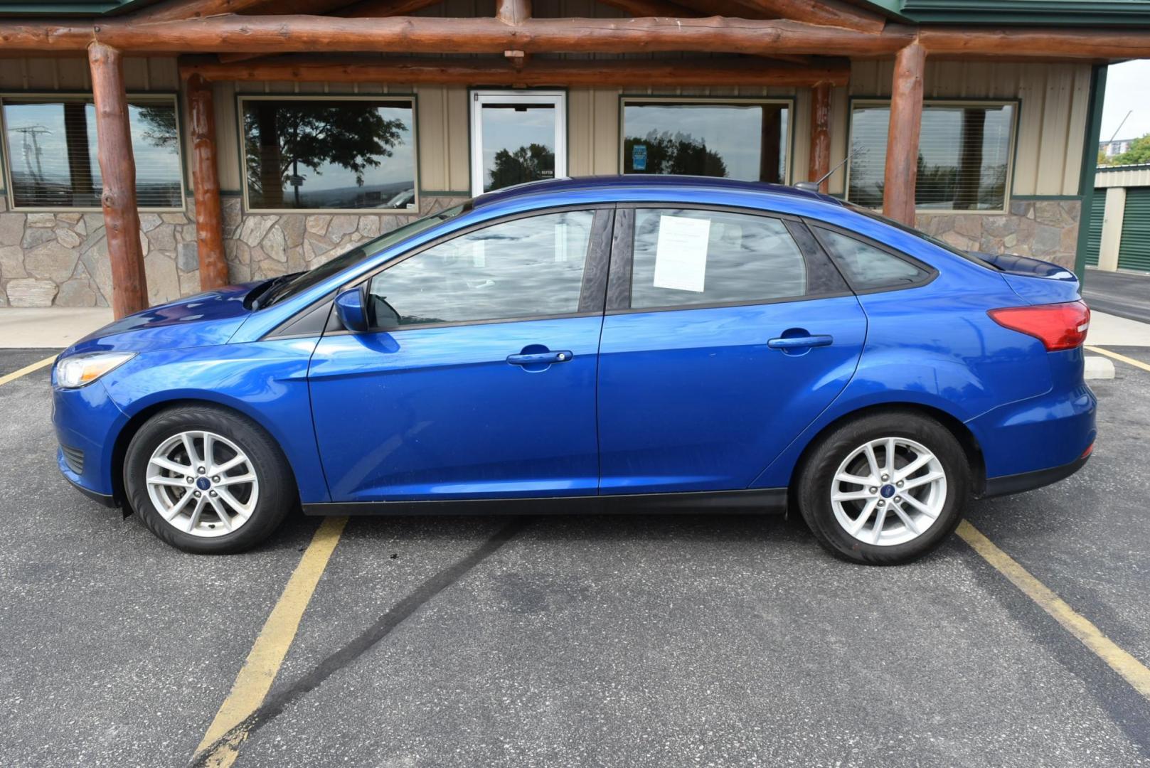 2018 Blue /Black Ford Focus SE (1FADP3F23JL) with an 2.0L L4 DOHC 16V engine, 6-Speed Automatic transmission, located at 1600 E Hwy 44, Rapid City, SD, 57703, (605) 716-7878, 44.070232, -103.171410 - Photo#4