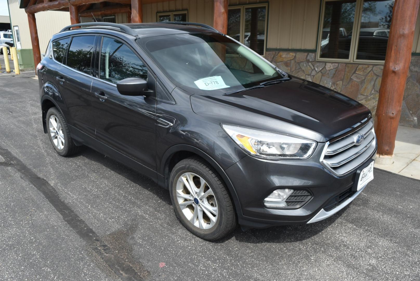 2018 Gray Ford Escape SE (1FMCU9GD6JU) with an 1.5L 4 Cyl Ecoboost engine, 6-Speed Automatic transmission, located at 1600 E Hwy 44, Rapid City, SD, 57703, (605) 716-7878, 44.070232, -103.171410- Photo#1