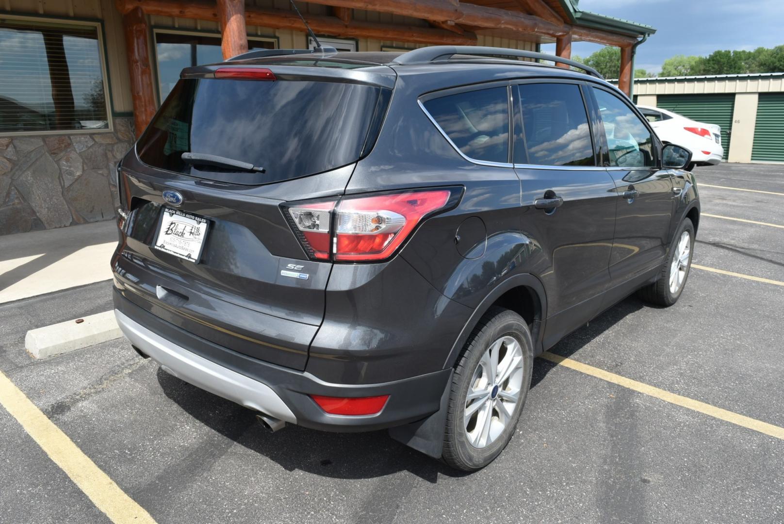 2018 Gray Ford Escape SE (1FMCU9GD6JU) with an 1.5L 4 Cyl Ecoboost engine, 6-Speed Automatic transmission, located at 1600 E Hwy 44, Rapid City, SD, 57703, (605) 716-7878, 44.070232, -103.171410- Photo#7